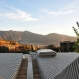 sunloungers fronting buildings near mountain